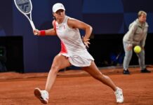 Iga Swiatek is hit by the ball and advances when Danielle Collins withdraws.