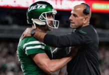 Aaron Rodgers and Robert Saleh laugh after being denied a hug as the New York Jets take the lead